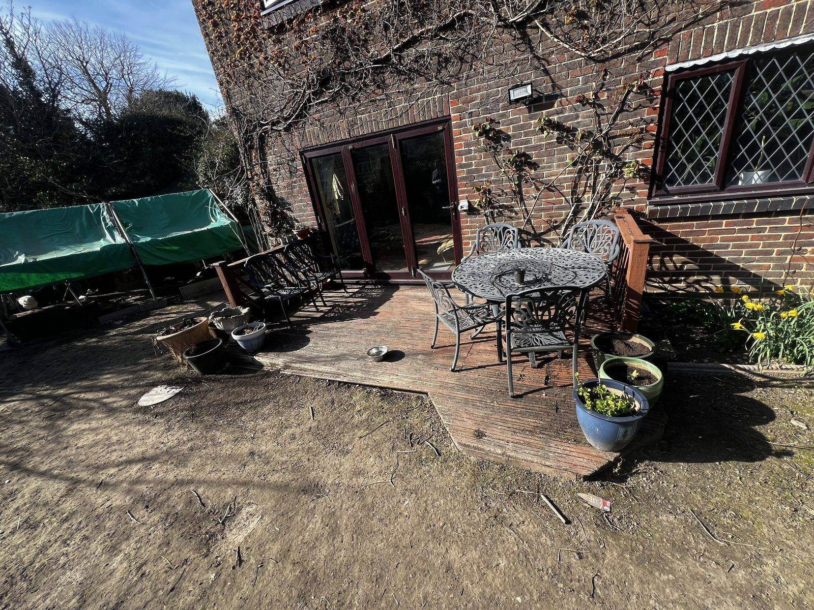 Bare ground and the old, broken timber decking before the garden refresh began