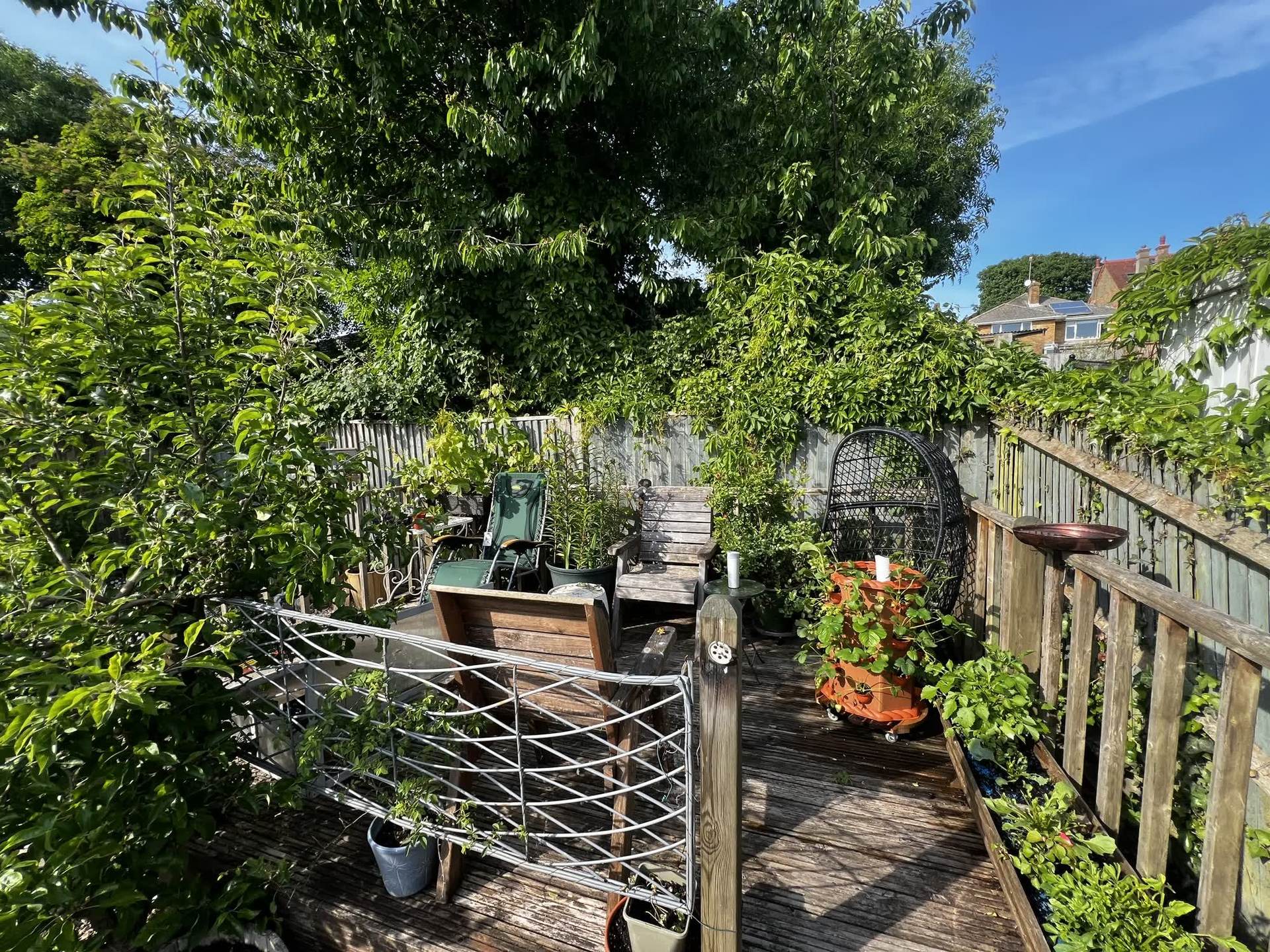 Overhead view of the cluttered old deck and garden furniture prior to the balustrade deck rebuild