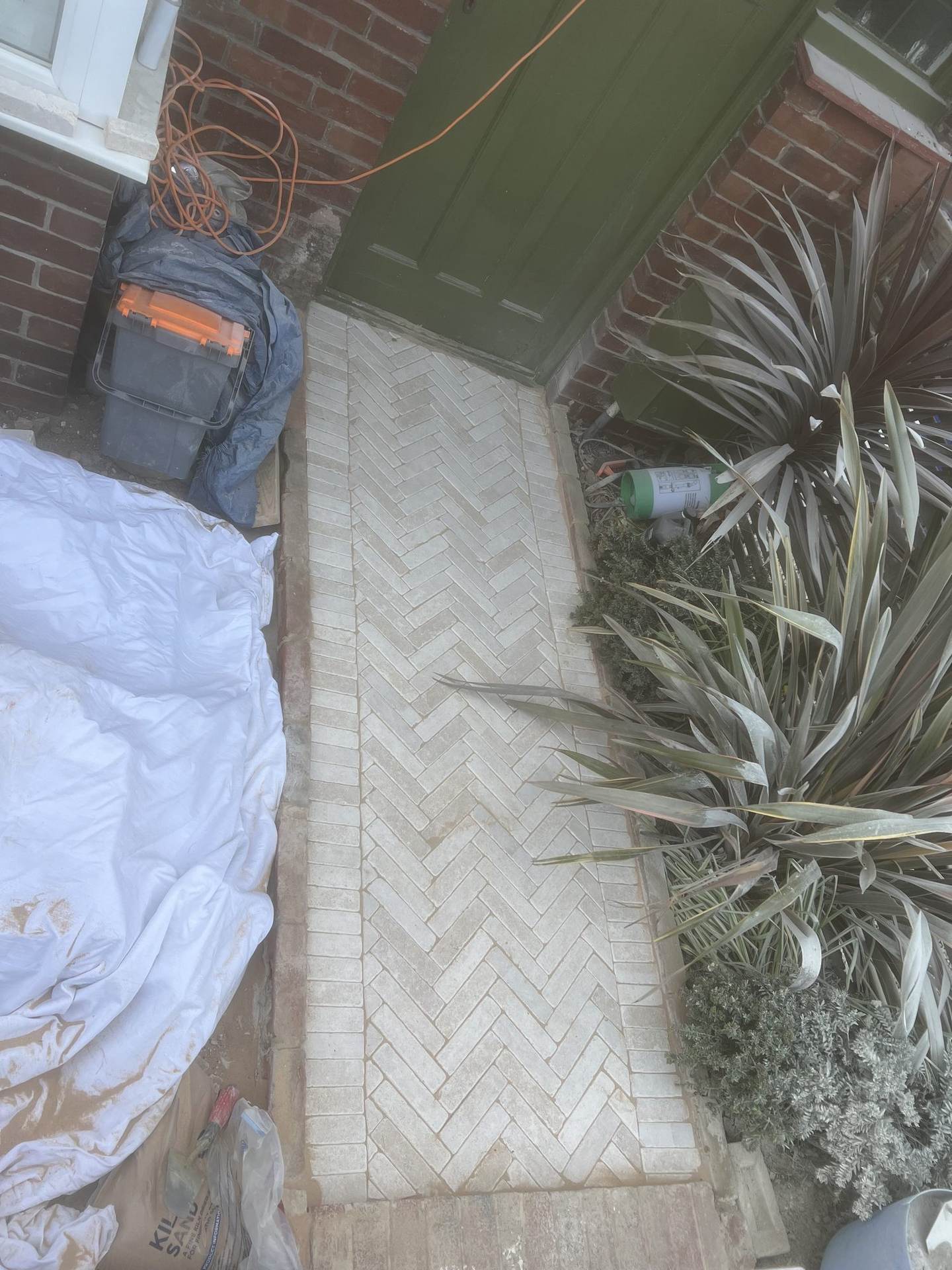 The herringbone limestone path being laid to the front door
